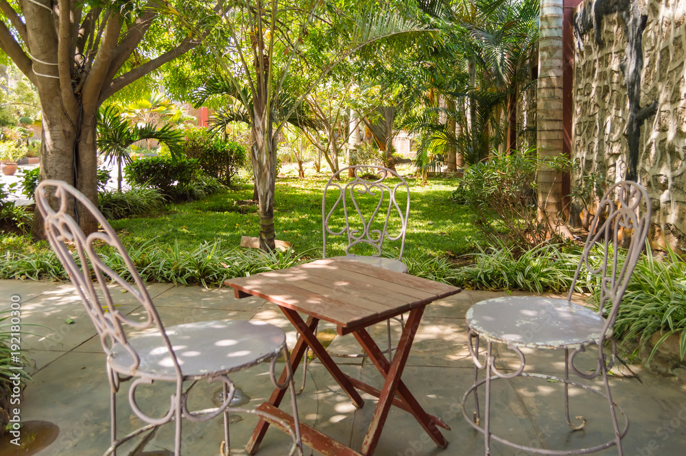 Sleeping corner with three iron chairs in a tropical garden in Nairobi Kenya
