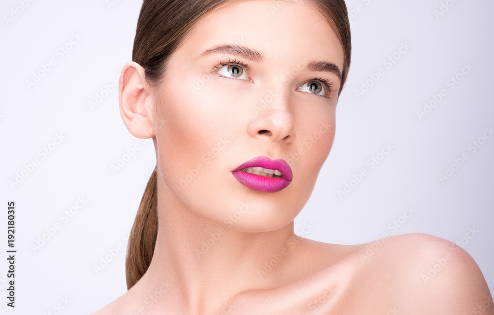 Beauty portrait of a beautiful young woman. Bright lips and professional make-up. Clean fresh skin Beauty portrait of a beautiful young woman. Bright lips and professional make-up. Clean fresh skin