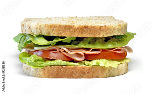 Delicious ham and cheese sandwich, isolated on white background. Gourmet toast or sandwich with lettuce, tomato, chess and turkey. Whole grain sandwich, healthy eating.