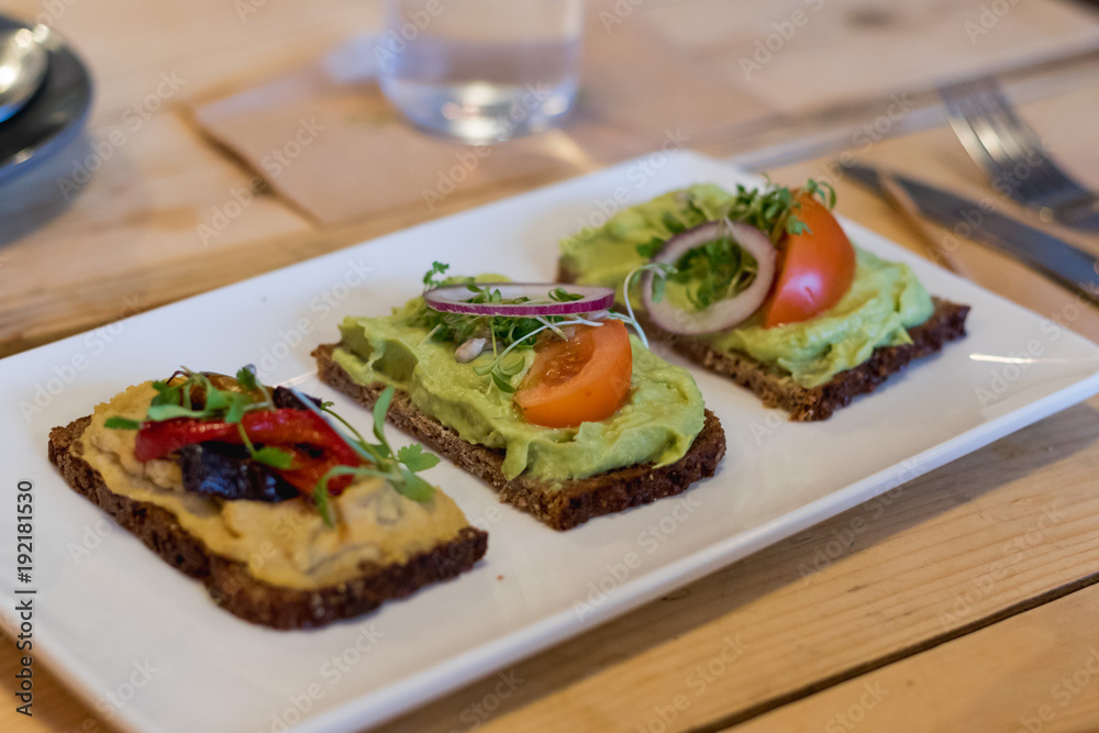 avocado and hummus on crackers