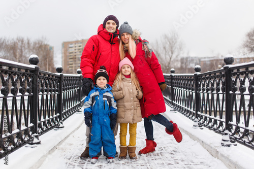 Photo of family with children in winter on bridge