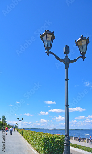 View on old style street lamp on the quay promenade of river Volga in the city Samara photo