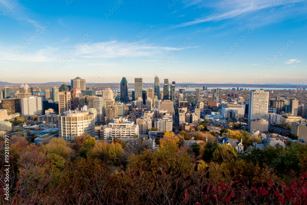 Montreal skyline from the Mont-Royal parc point of view at the end of fall with a bright blue sky.