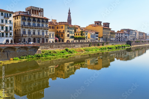 Buildings on the banks of the Arno River in the city of Florence. Italian architecture. Urban landscape in Italy. Reflections on water. June 2017.