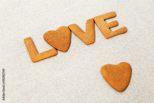 Wallpaper Mural The word Love from homemade cookies with ginger on canvas natural tablecloth. Cookies in heart shape. Selective focus and Copy space. Torontodigital.ca