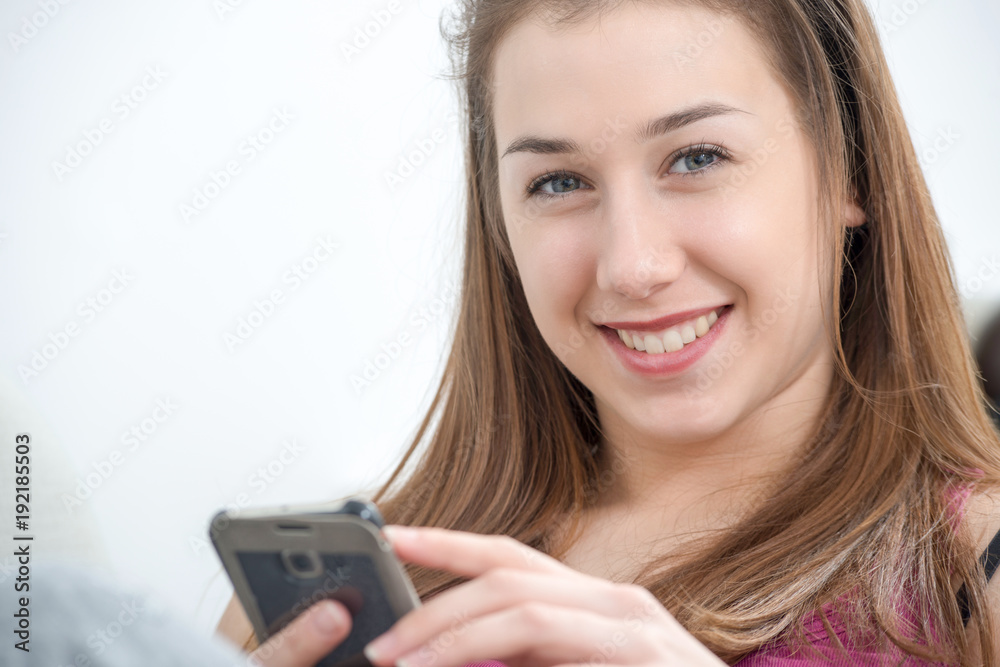 young and smiling woman using smartphone at home young and smiling woman using smartphone at home