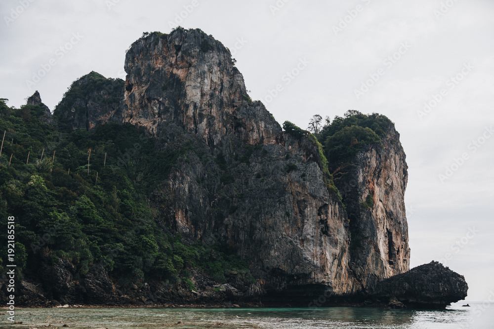 scenic cliffs with green vegetation and transparent water at Phi-Phi island, Thailand scenic cliffs with green vegetation and transparent water at Phi-Phi island, Thailand