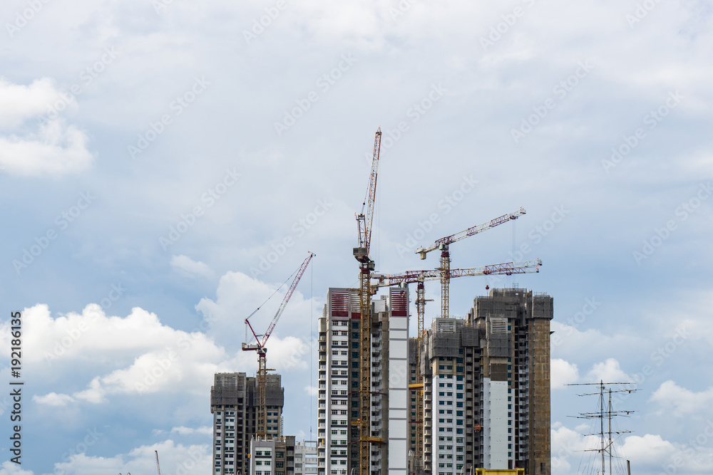 Singapore High rise tower with crane under construction Singapore High rise tower with crane under construction