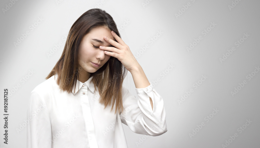 Indoor portrait of sad young asian student covering her face with hands. Emotions, feelings, lifestyle concept. Indoor portrait of sad young asian student covering her face with hands. Emotions, feelings, lifestyle concept.