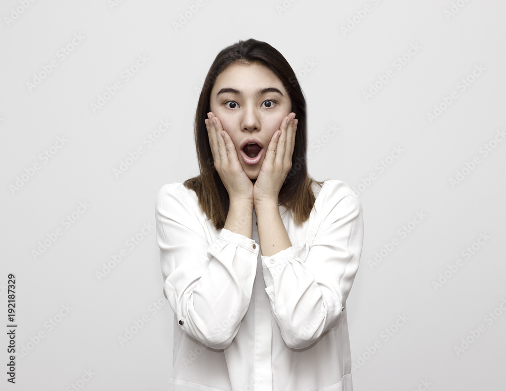 Indoor shot of shocked elegant woman in formal style looks with wide eyed expression being horrified to find out something bad, wonders how it happened. Shocking news Indoor shot of shocked elegant woman in formal style looks with wide eyed expression being horrified to find out something bad, wonders how it happened. Shocking news