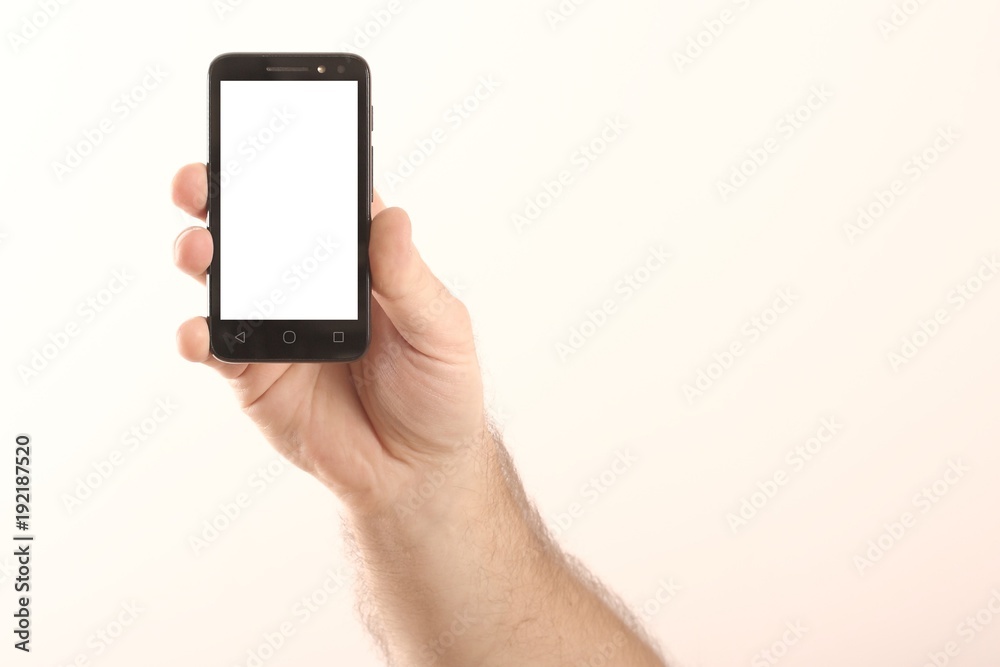 Male hand and smart phone isolated on white background. Male hand and smart phone isolated on white background.