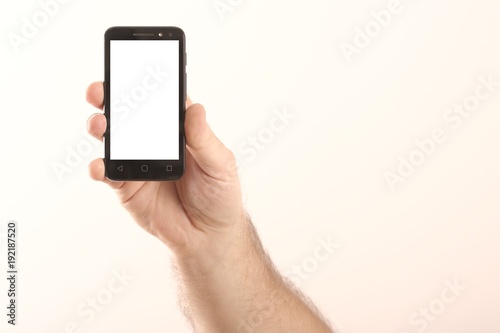 Male hand and smart phone isolated on white background.