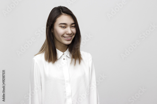 Indoor portrait of young attractive woman making funny face and showing unrecognizable emotion. Facial expressions, lifestyle concept
