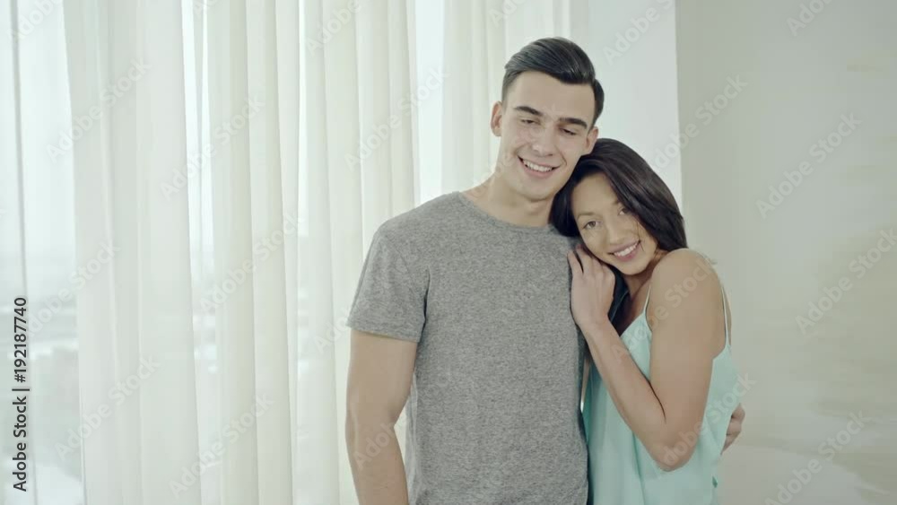 Affectionate couple in a close embrace smiling Affectionate couple in a close embrace smiling
