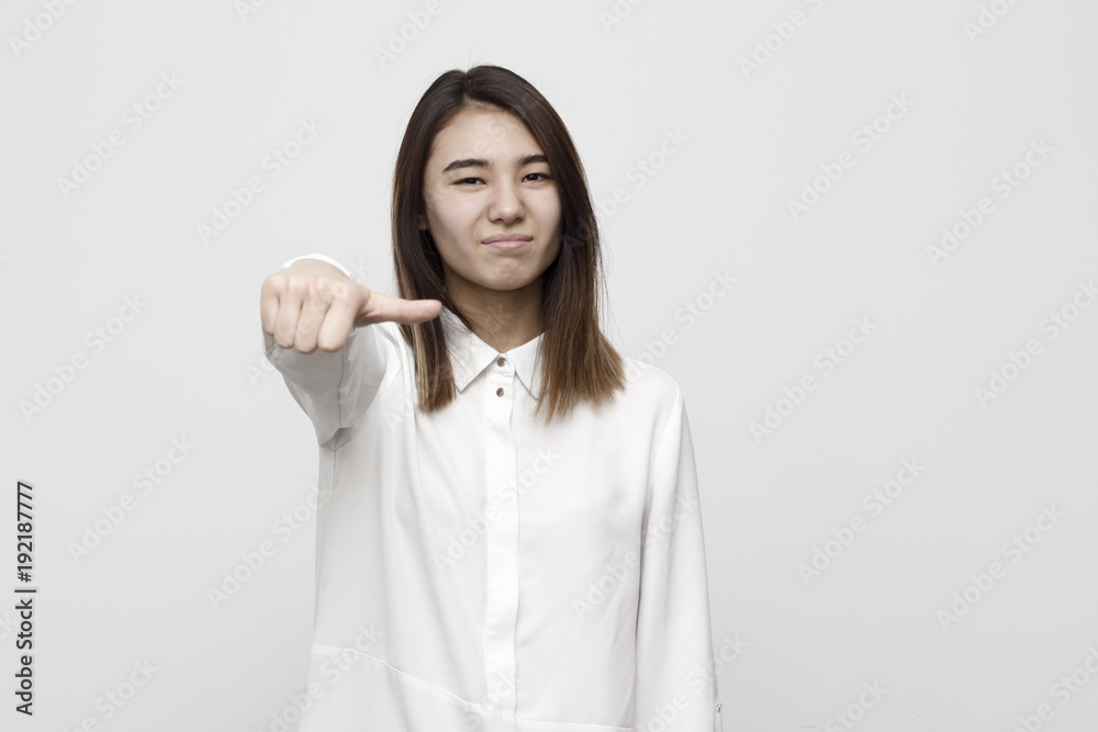 Woman giving an equal thumb gesture with a grimace showing that she is undecided, abstaining, impartial or indifferent in a vote, upper body Woman giving an equal thumb gesture with a grimace showing that she is undecided, abstaining, impartial or indifferent in a vote, upper body
