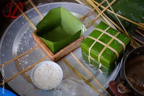 Packing Banh Chung (sticky rice cake), this is a traditional Vietnamese rice cake which is made from glutinous rice, mung beans, pork and other ingredients.