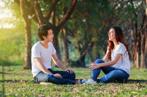 young couple talking and laghing in park