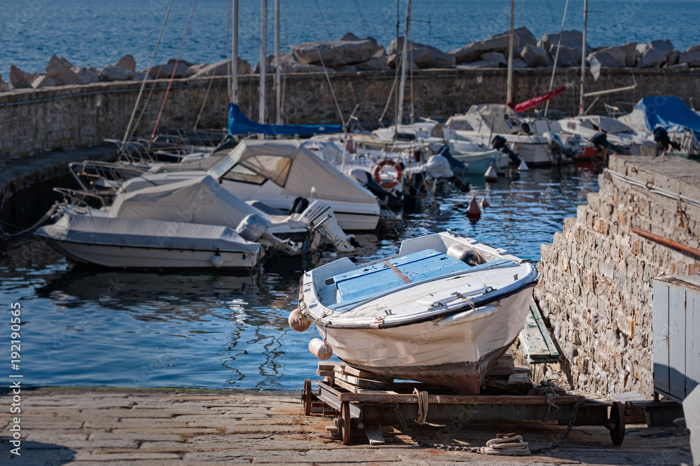 Boat on cart for maintenance in harbor. Boat on cart for maintenance in harbor.