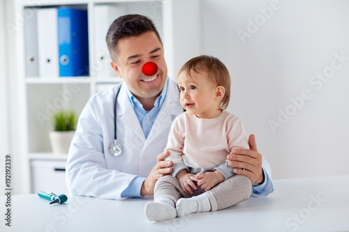 happy baby girl at doctor on red nose day