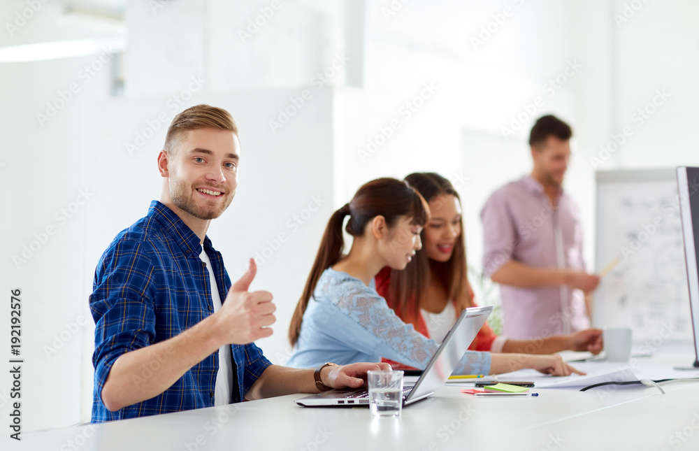 happy man with creative team at office conference happy man with creative team at office conference
