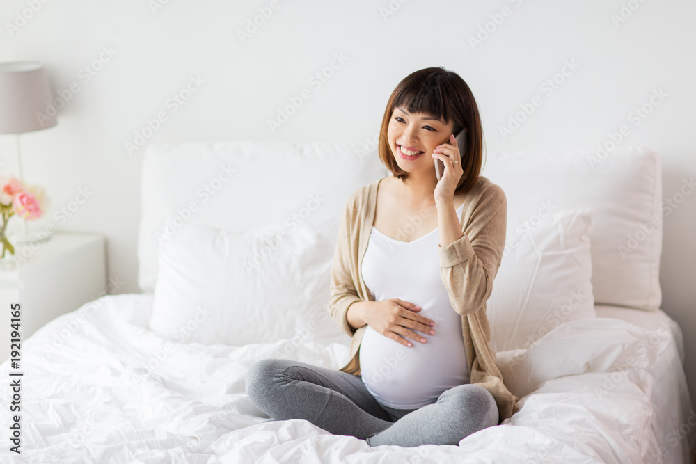 happy pregnant woman calling on smartphone at home happy pregnant woman calling on smartphone at home