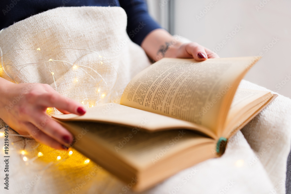 Female hands with a book while reading. Female hands with a book while reading.