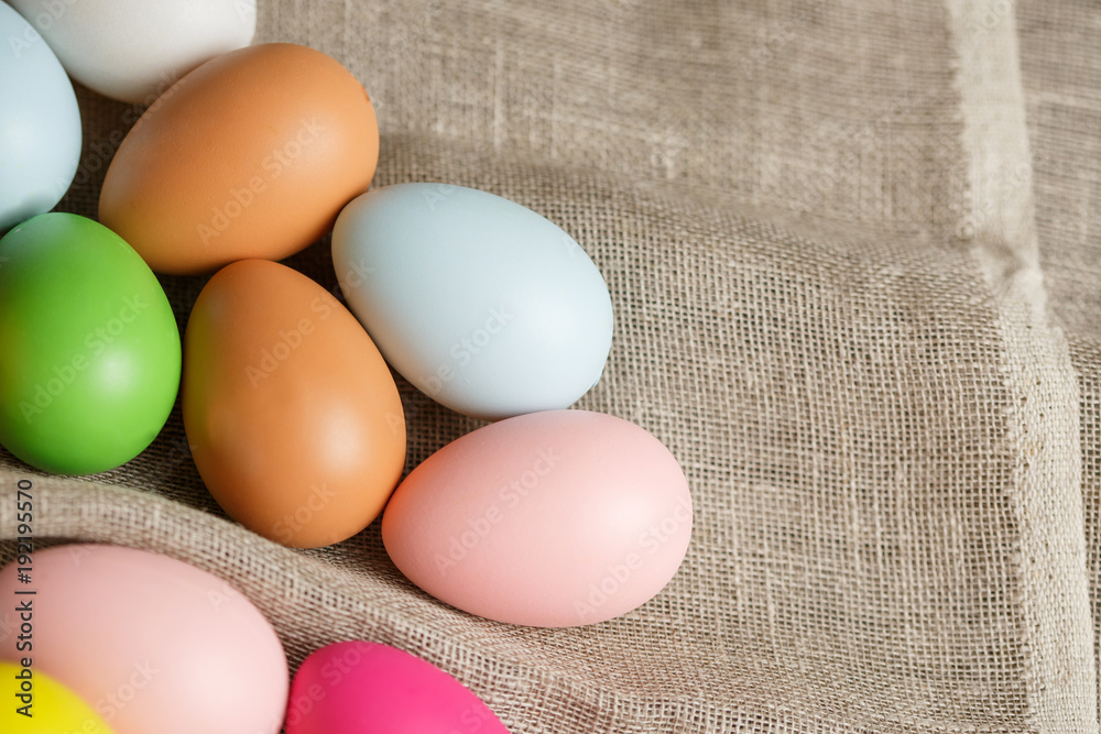 Painted Easter eggs on sackcloth, rustic festive composition Painted Easter eggs on sackcloth, rustic festive composition