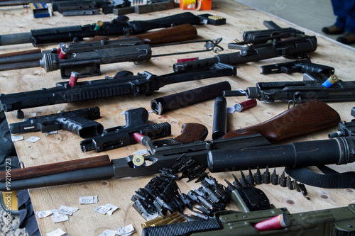 A table with various machine gun rifles