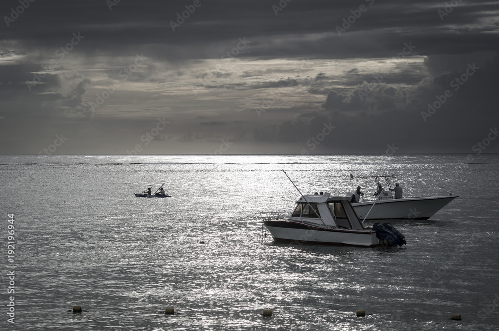 fishing white boats at sea at sunset on Mauritius Island