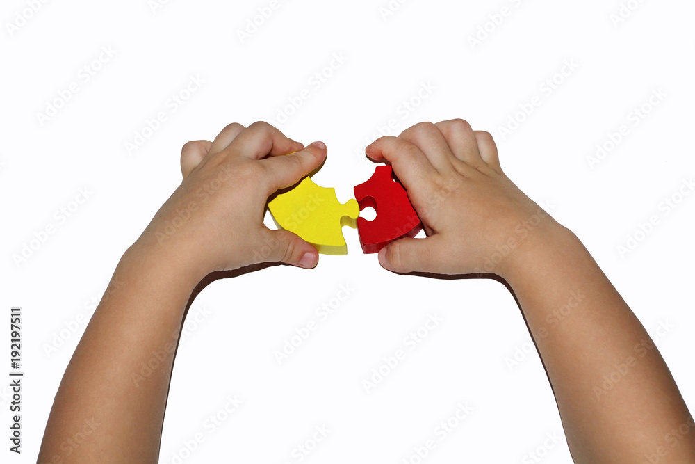 The baby's hand is a picking puzzle on a white background. Two parts of the puzzle do not converge to a heavy problem solution The baby's hand is a picking puzzle on a white background. Two parts of the puzzle do not converge to a heavy problem solution
