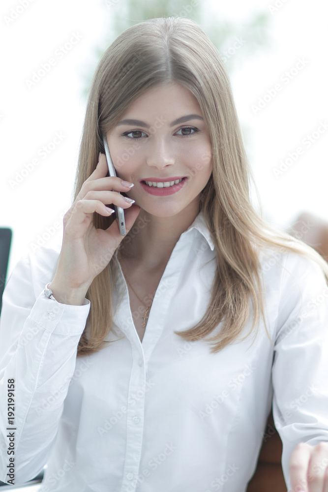 business woman talking on mobile phone sitting in the office business woman talking on mobile phone sitting in the office
