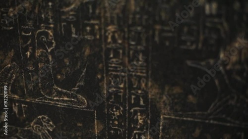 Close up old hieroglyphics on black wall, ancient works pictographic shape background stone art animal egypt tomb travel landmark nile religion temple civilization traditional culture history pharaoh photo