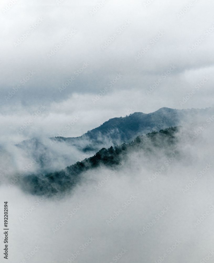 View of mountains covered with fog View of mountains covered with fog