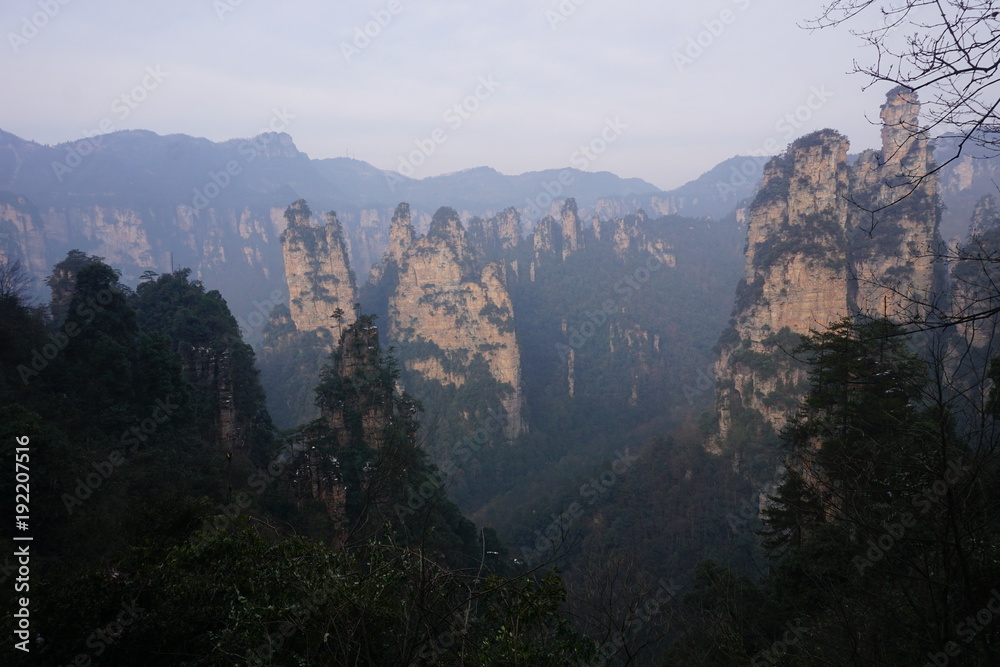 Fototapeta premium Mountains in China with trees and dust in sunshine