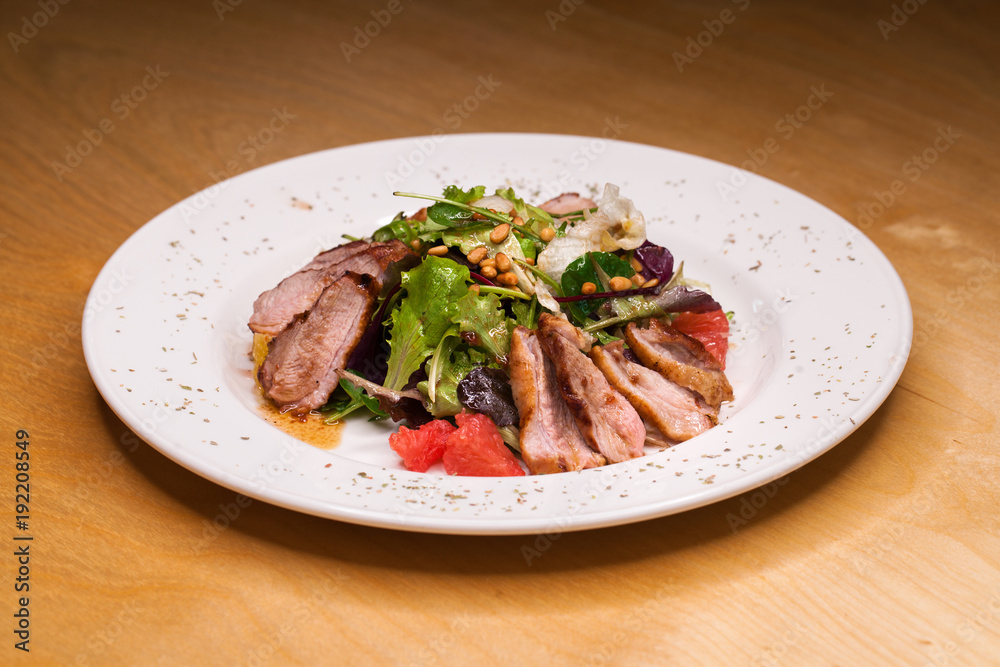 Restaurant dish meat salad from pork and arugula