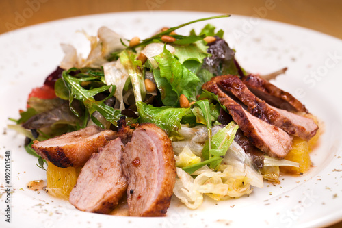 Restaurant dish meat salad from pork and arugula