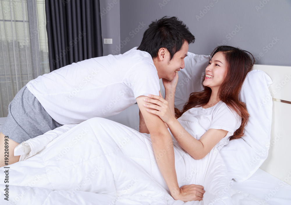 lovely couple lying in a bed and looking to each other (eyes to eyes) lovely couple lying in a bed and looking to each other (eyes to eyes)
