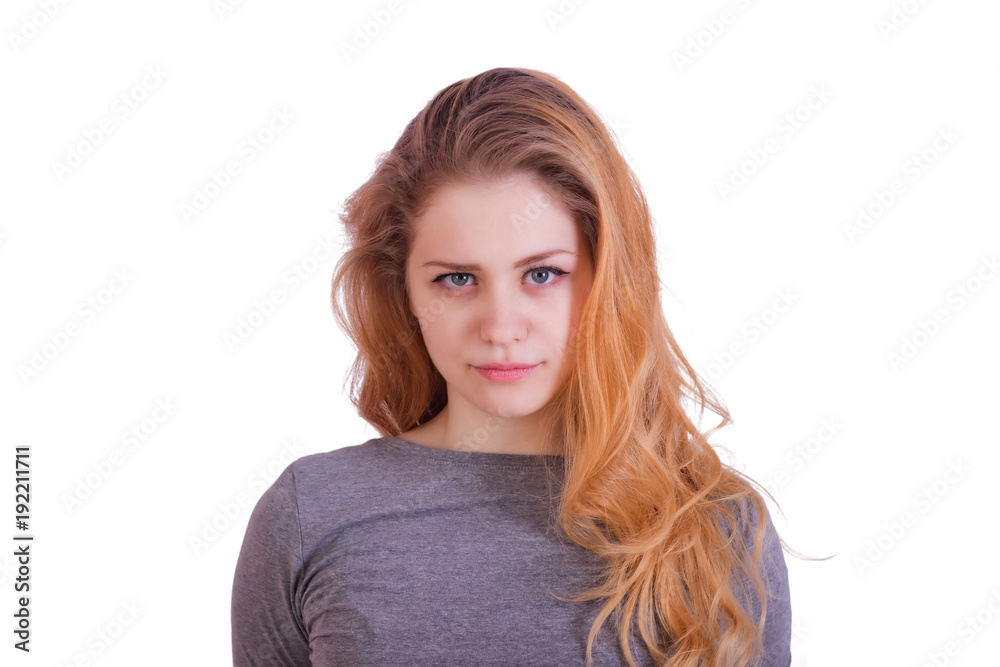 Portrait of a charming red-haired long-haired girl looking directly into the camera Portrait of a charming red-haired long-haired girl looking directly into the camera