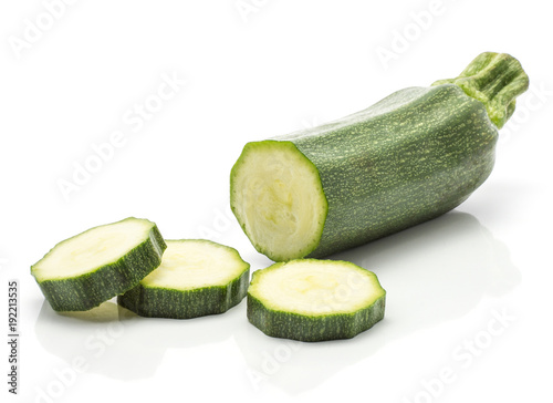 Green zucchini one sliced half three round slices isolated on white background long raw courgette.
