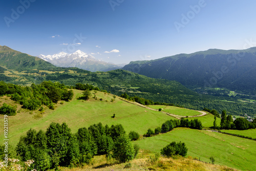 Beautiful natural landscape with green meadows. The mountains in the background. The village of Mestia, Svaneti, Georgia.