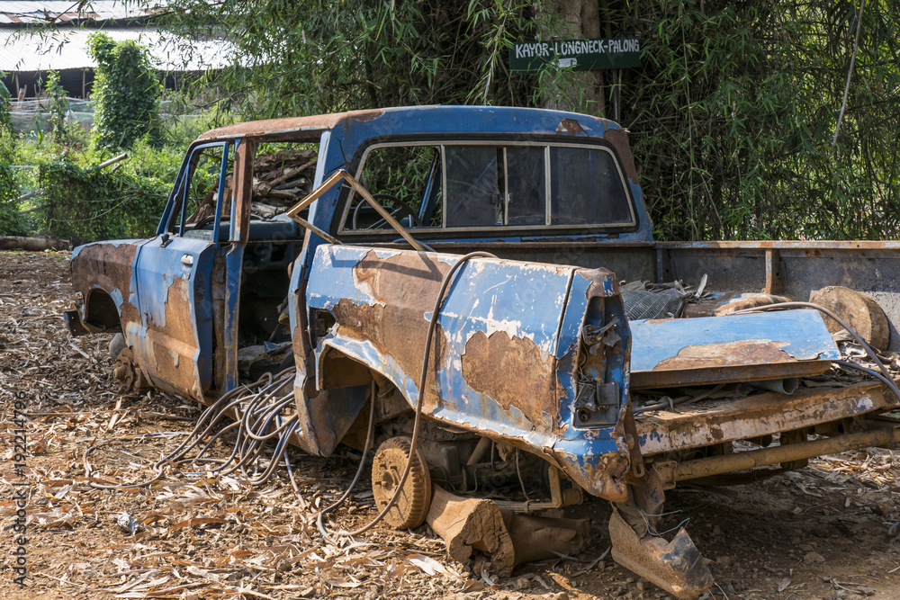 rusted car wreck in a Hill Tribe Village rusted car wreck in a Hill Tribe Village