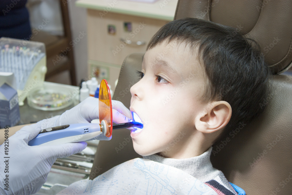 Dentist is treating a boy's teeth Dentist is treating a boy's teeth