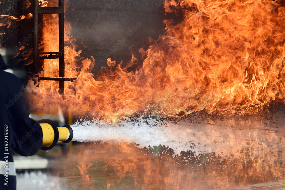 Obraz premium Firemen ,Fireman in action activated foam . ,Background for emergency response .