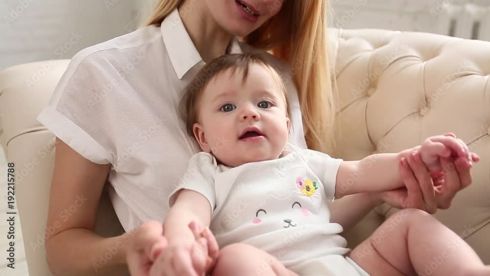 Young mother holding her newborn kid. Happy mom nursing baby. Woman and new born girl together in a white bedroom at home. Mother breast feeding baby. Family lifestyle Young mother holding her newborn kid. Happy mom nursing baby. Woman and new born girl together in a white bedroom at home. Mother breast feeding baby. Family lifestyle