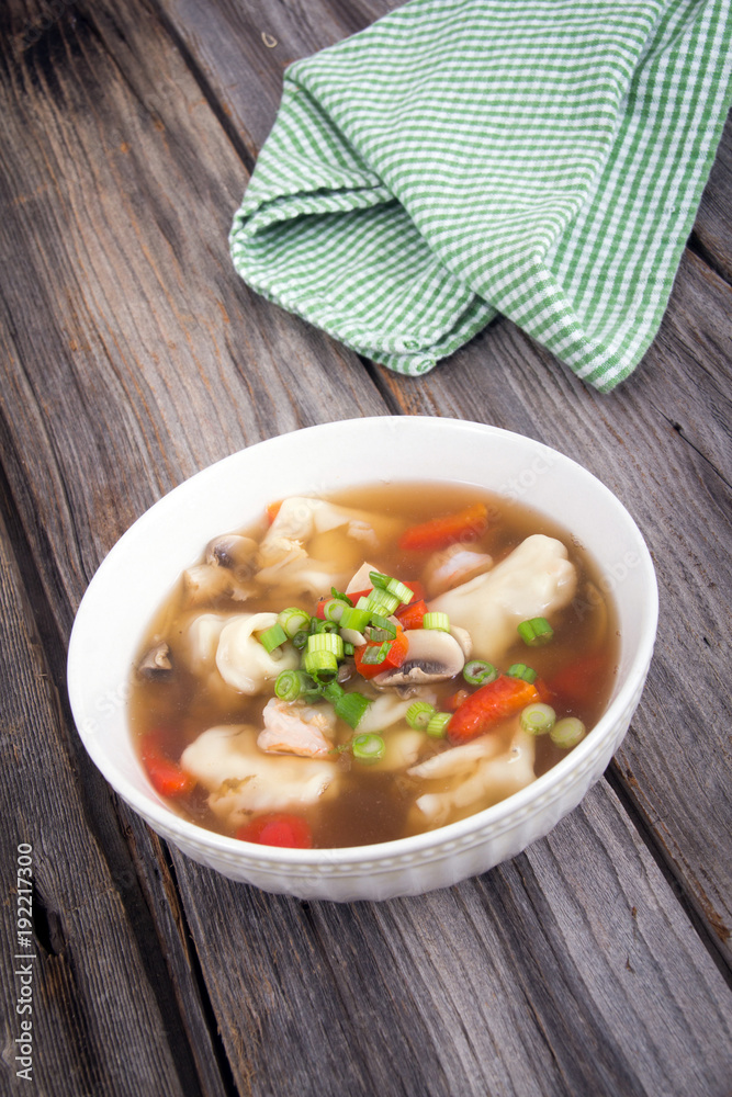 dumpling soup with green onion on wood table dumpling soup with green onion on wood table