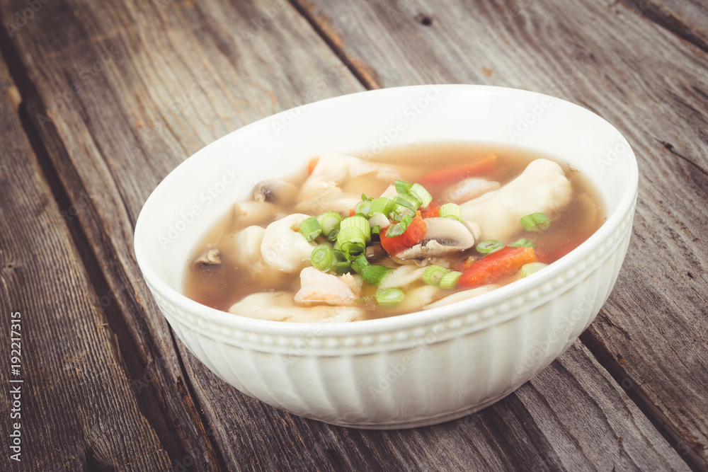 dumpling soup with green onion on wood table dumpling soup with green onion on wood table