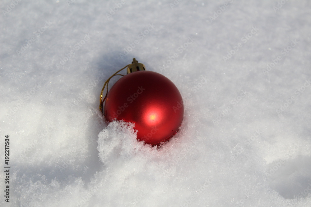 Christmas ball toy in the snow.