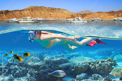 Young woman at snorkeling in the tropical water photo