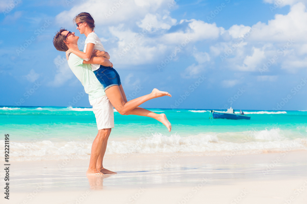 happy young couple having fun by the beach happy young couple having fun by the beach