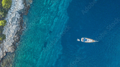 Fototapeta Naklejka Na Ścianę i Meble -  Aerial view of anchoring yacht next to the island.